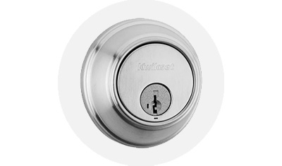 Kwikset 817 Collection Residential Deadbolt product isolated on top of a gray circle